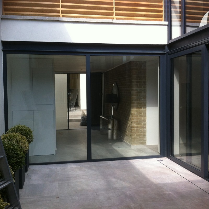 Floor-to-ceiling sliding doors opening to courtyard in Chingford