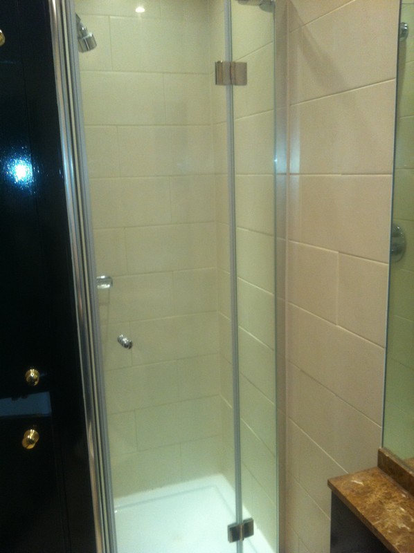 Frameless glass shower enclosure with chrome fittings in Chingford